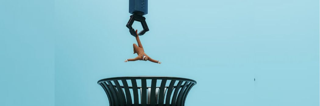 Graphic drawing of a robotic hand dropping a worker into a waste bin
